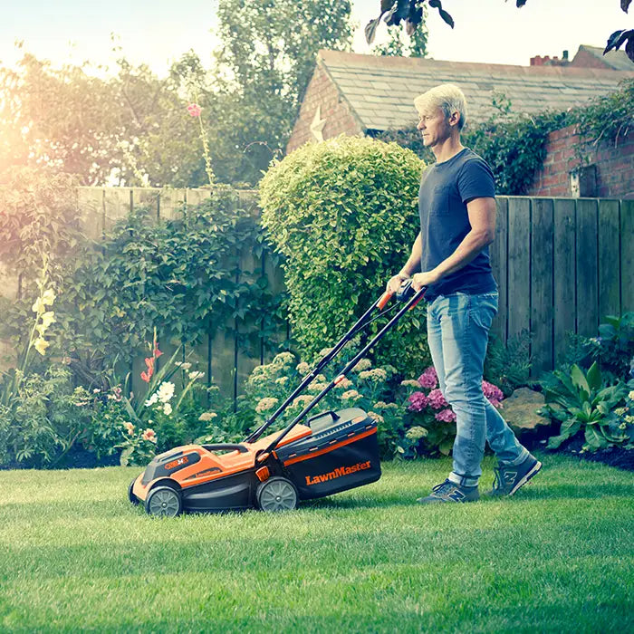 LawnMaster MX 24V 34cm Cordless Mower cutting grass on UK lawn