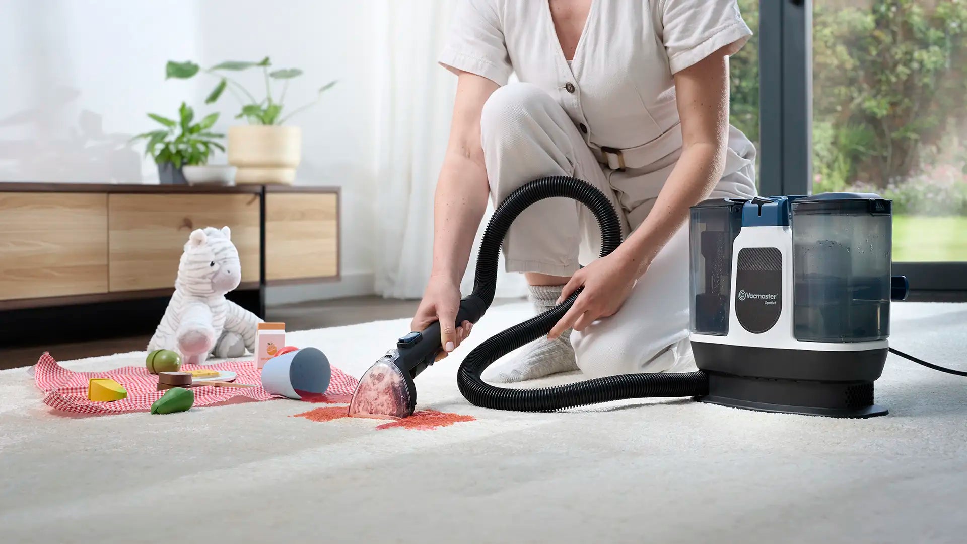 Vacmaster Spotlet Carpet Spot Cleaner cleaning spilled juice stain from rug