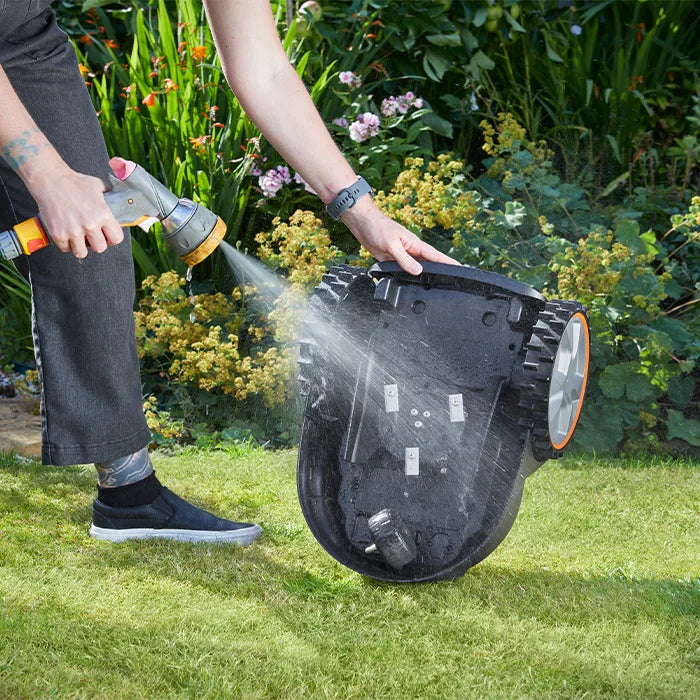 IPX5 Washable Mower being cleaned with garden hose