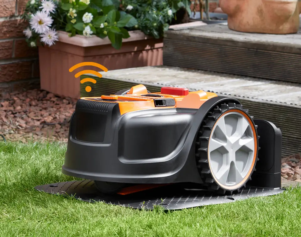 AMB16i4 Robot Lawnmower in the docking station on the lawn with wifi connection