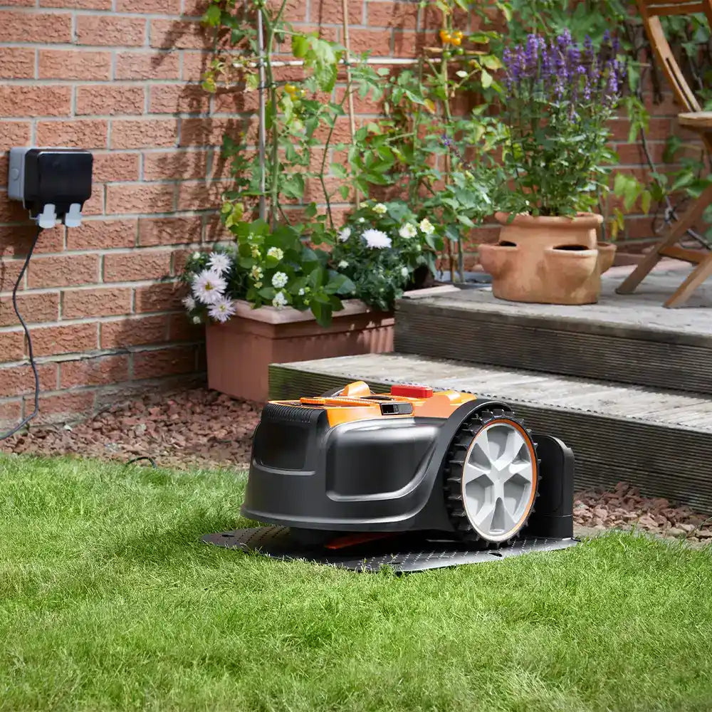 Auto charging Robot Vacuum Cleaner on charging dock in garden