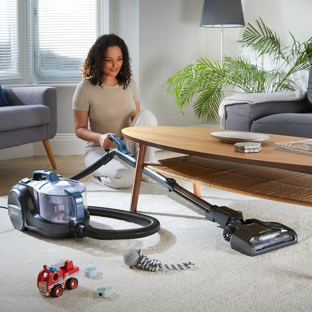 Vacmaster Vortica Cannister Vacuum Cleaner vacuuming under a table