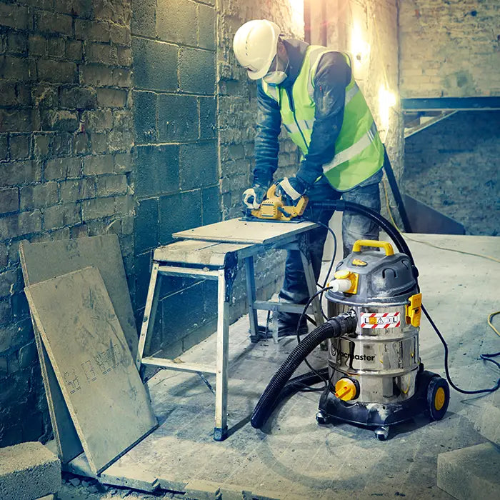 Vacmaster vacuum cleaner on building site extracting dust with connected power tool