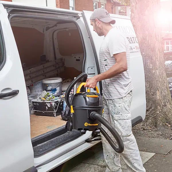 Decorator putting Vacmaster D8 vacuum cleaner in van