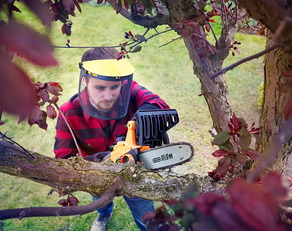 LawnMaster Chainsaw cutting a tree branch