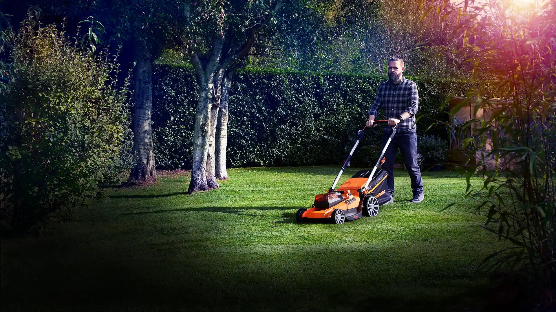 LawnMaster cordless lawnmower on large UK garden