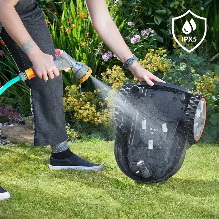 Robot Mower OcuMow AMB16-400 deck being power washed with IPX 5 Rating LawnMaster
