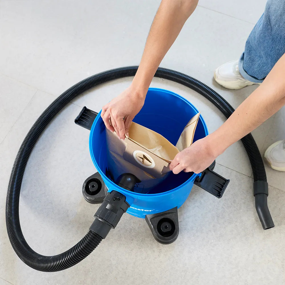 Inserting dust bag into Vacmaster Multi WD16 wet and dry vacuum cleaner