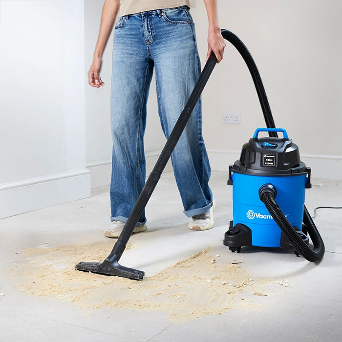 Vacmaster wet and dry vacuum cleaner cleaning sawdust from floor