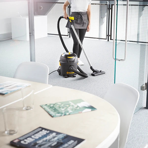 Cleaner vacuuming office meeting room with Vacmaster D8 hoover