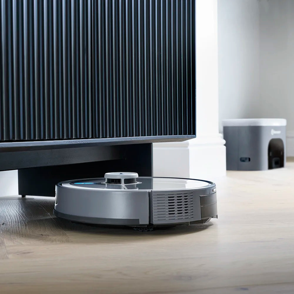 Robot Vacuum Cleaner REi hoovering wooden floor under low furniture 