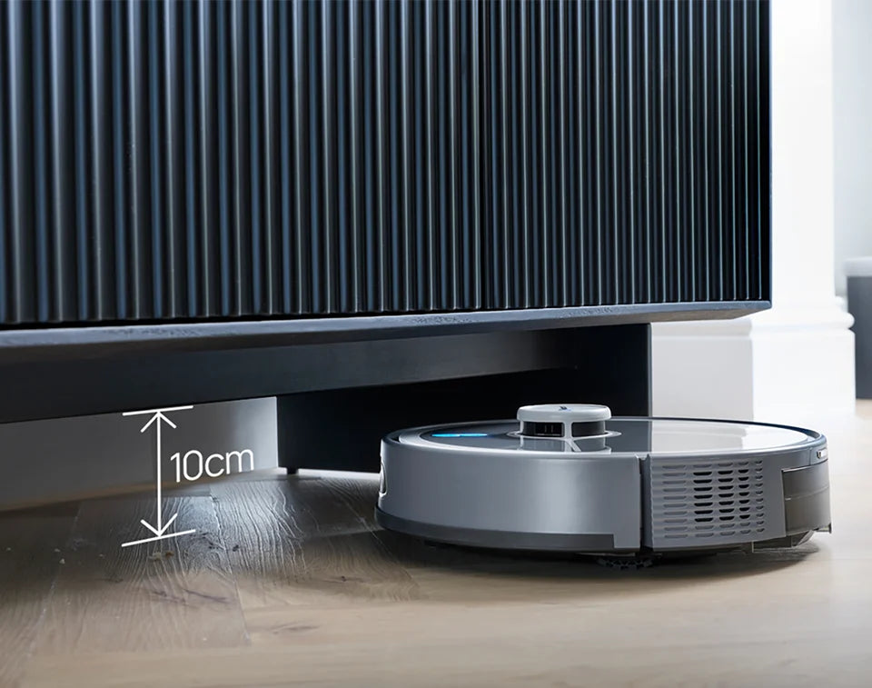 Robot vacuum cleaner Vacmaster REi vacuuming under low profile sideboard