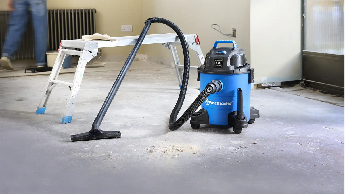 Vacmaster Multi WD16 Wet and dry vacuum cleaner on the dirty floor of a room that's being decorated 