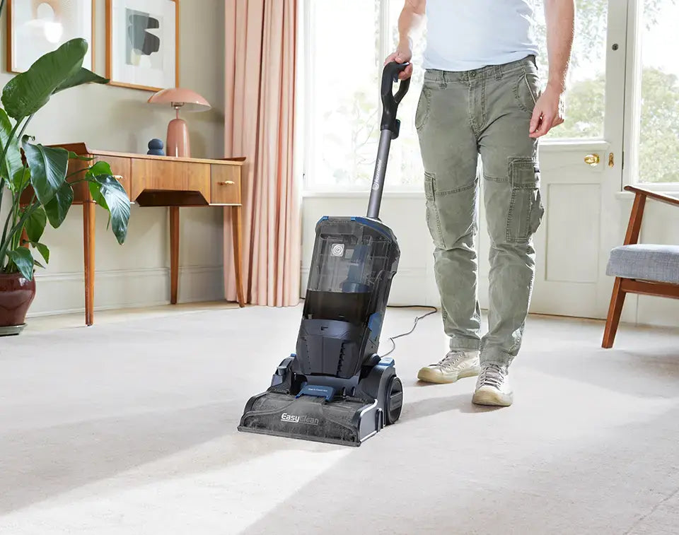 The Vacmaster EasyClean Home Carpet Cleaner deep cleaning a large room with carpet and rug