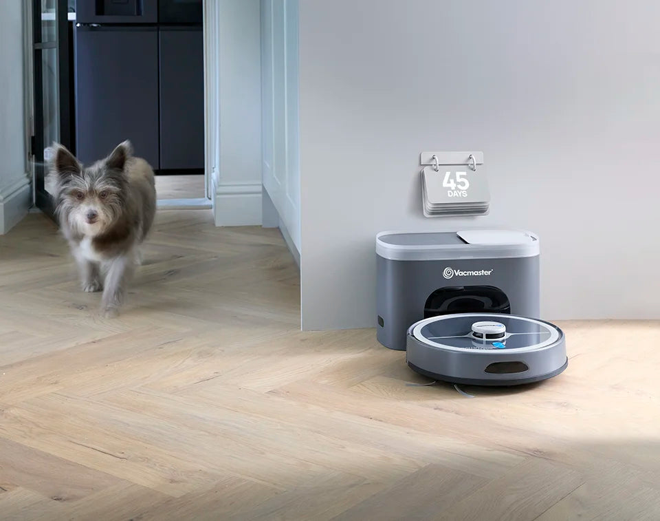 Vacmaster robot vacuum cleaner with elf empty station docked in kitchen with  dog