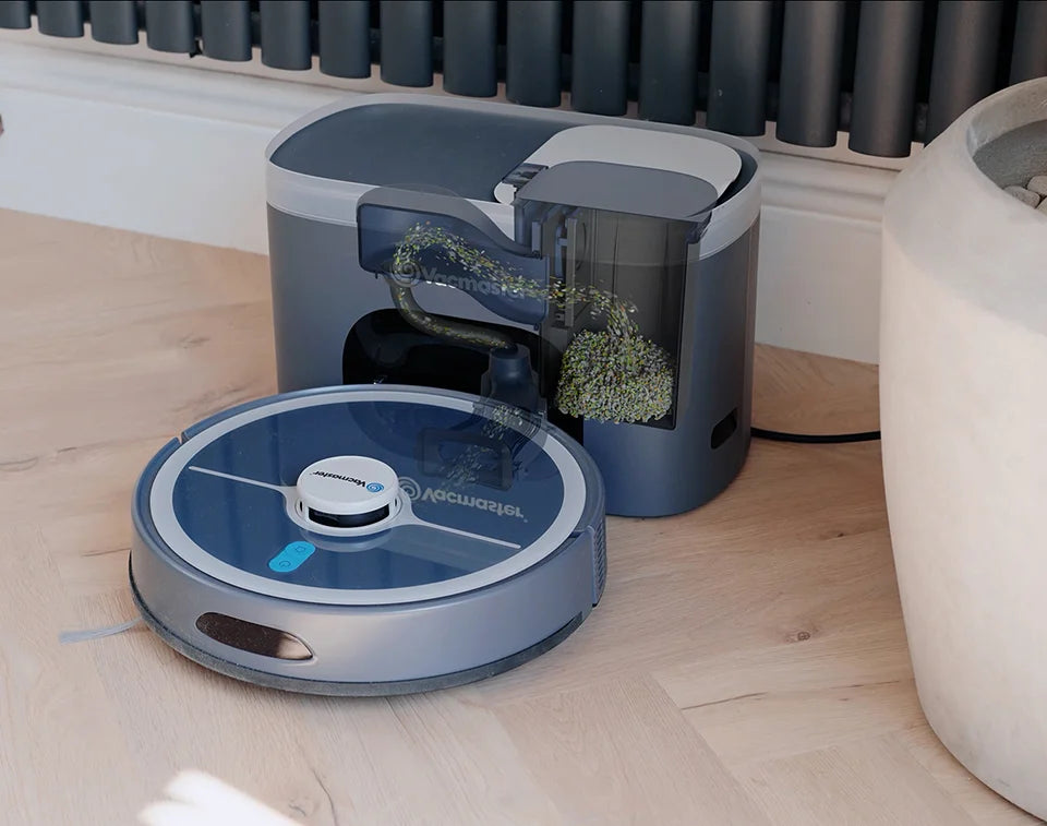 Robot vacuum cleaner Vacmaster REi docked on self empty station emptying dust into bin in kitchen 