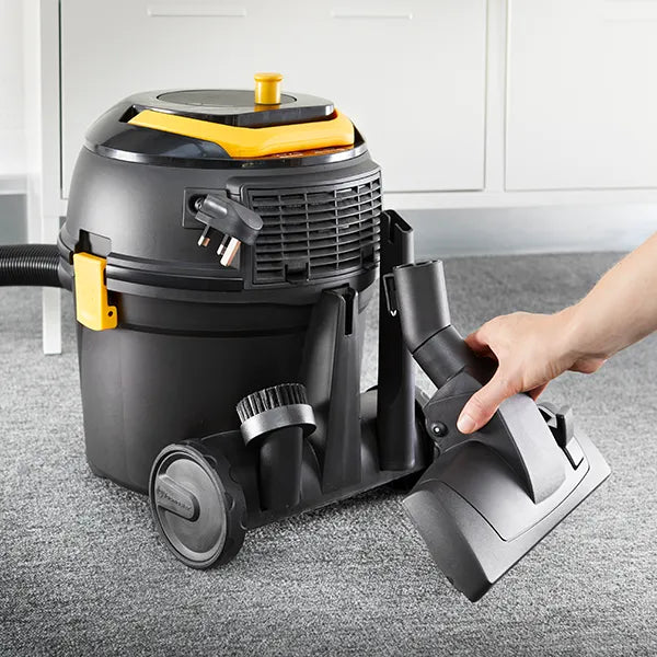 Person storing vacuum cleaner tools on Vacmaster D8 cylinder hoover