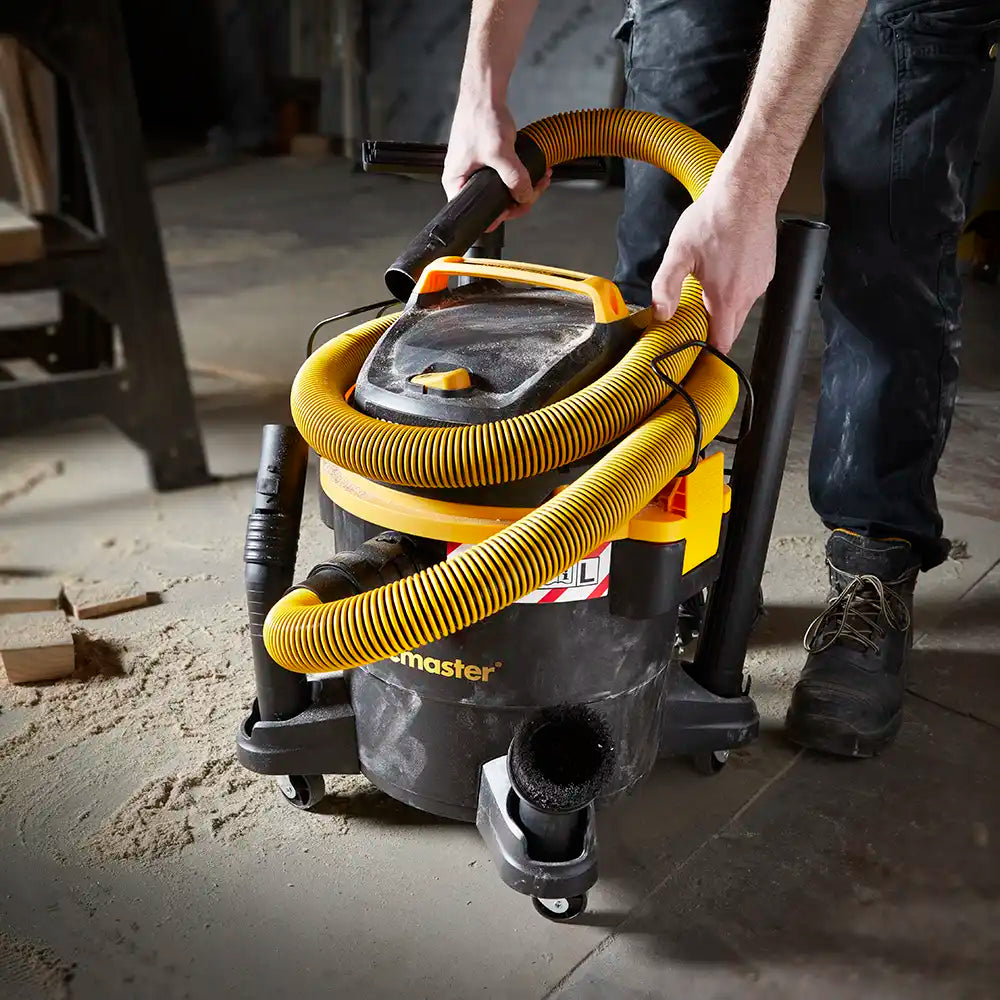 Wet and Dry dust extractor vacuum cleaner Vacmaster WD L23 hose being clipped to vacuum body