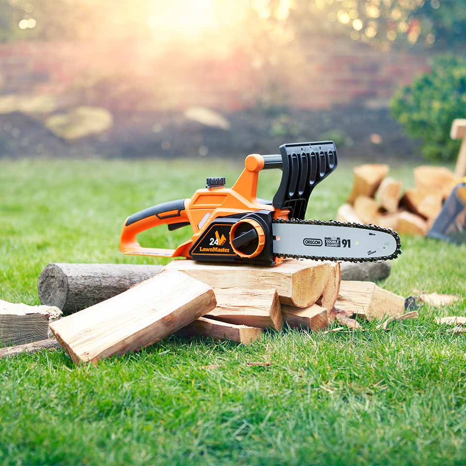 Cordless Chainsaw 24V 25cm LawnMaster on pile of chopped fire wood