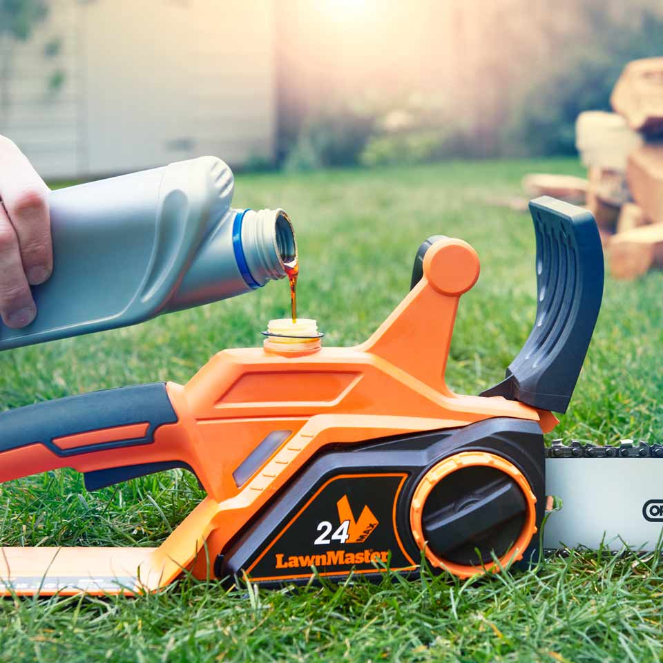 Cordless Chainsaw MX 24V Bare Tool LawnMaster being topped up with chain oil