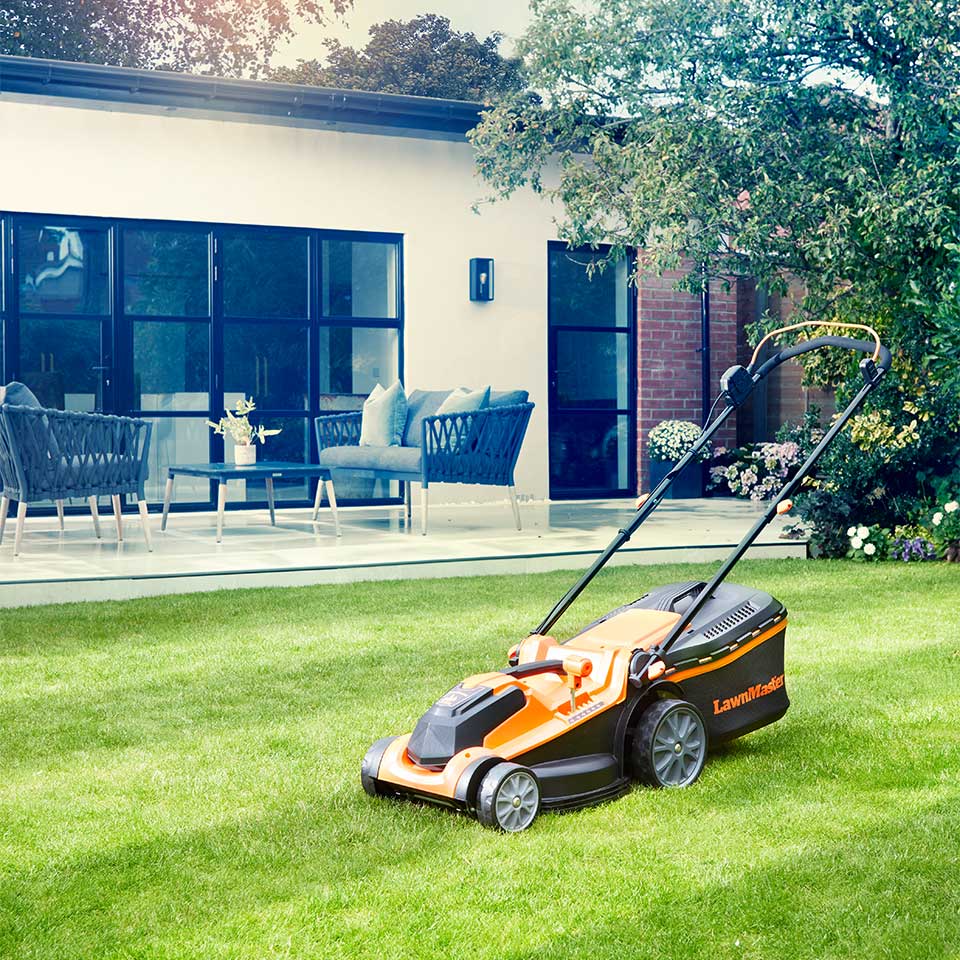 LawnMaster cordless lawn mower 24v on garden with striped lawn