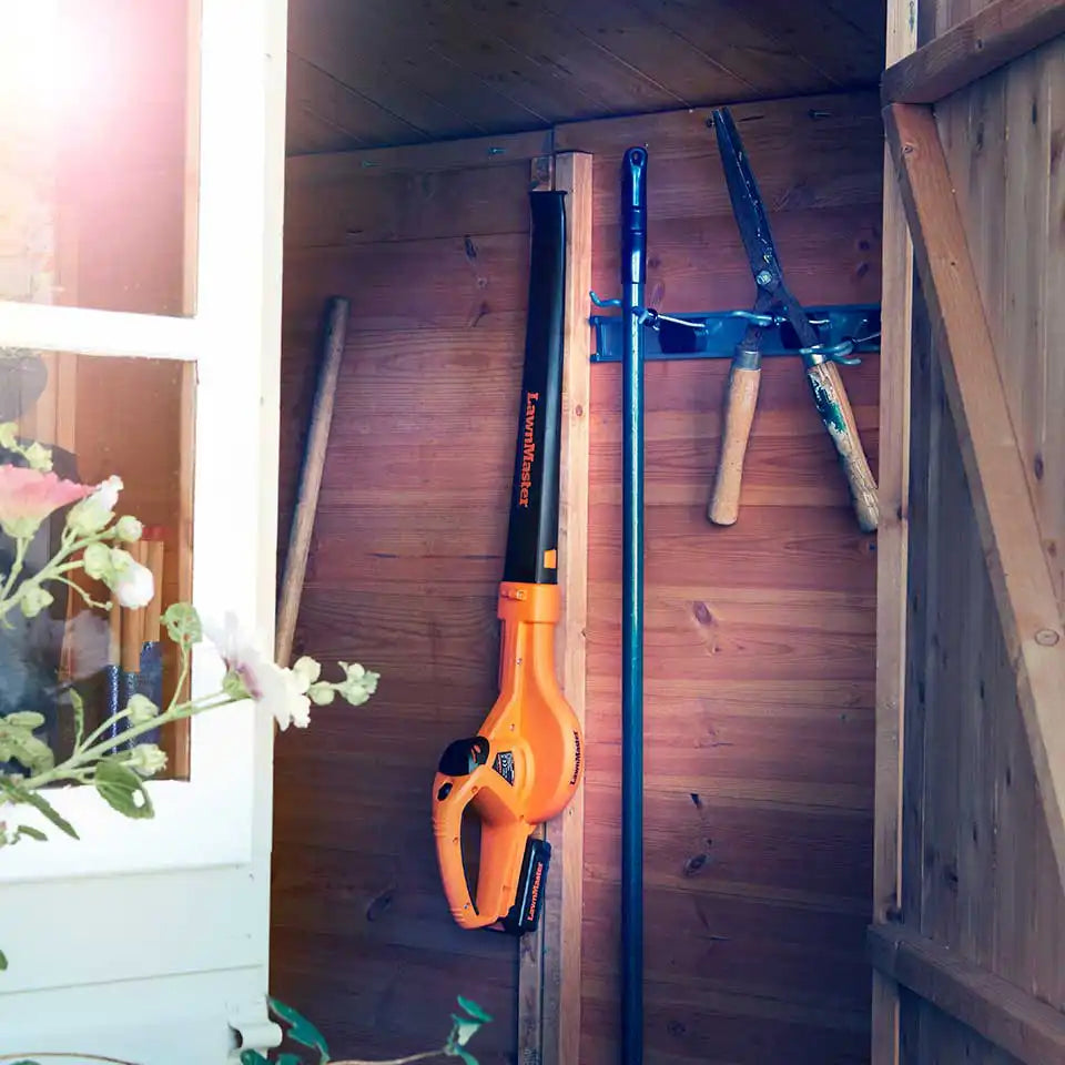 LawnMaster 24V Cordless Garden Blower being stored using storage hook