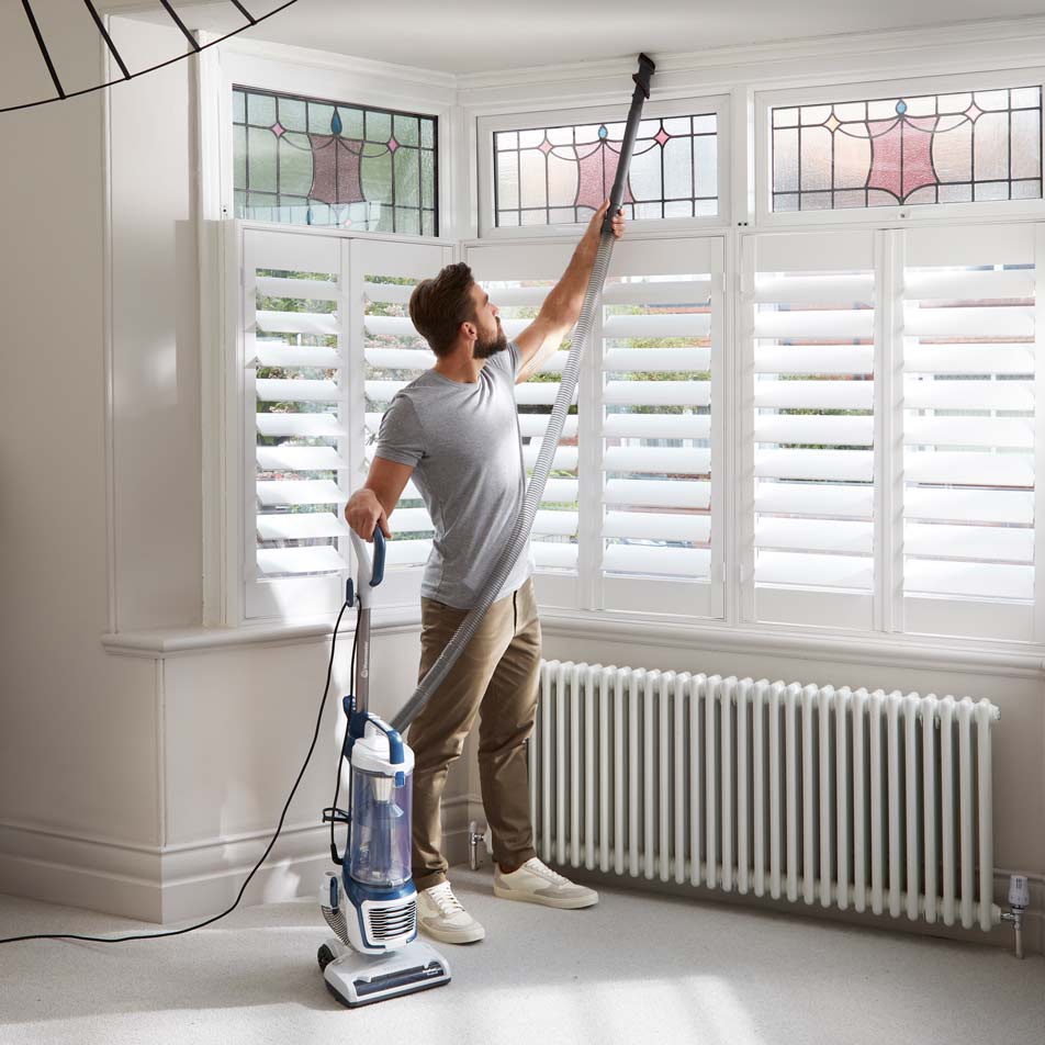 Vacmaster Respira Bagless Vacuum reaching up high