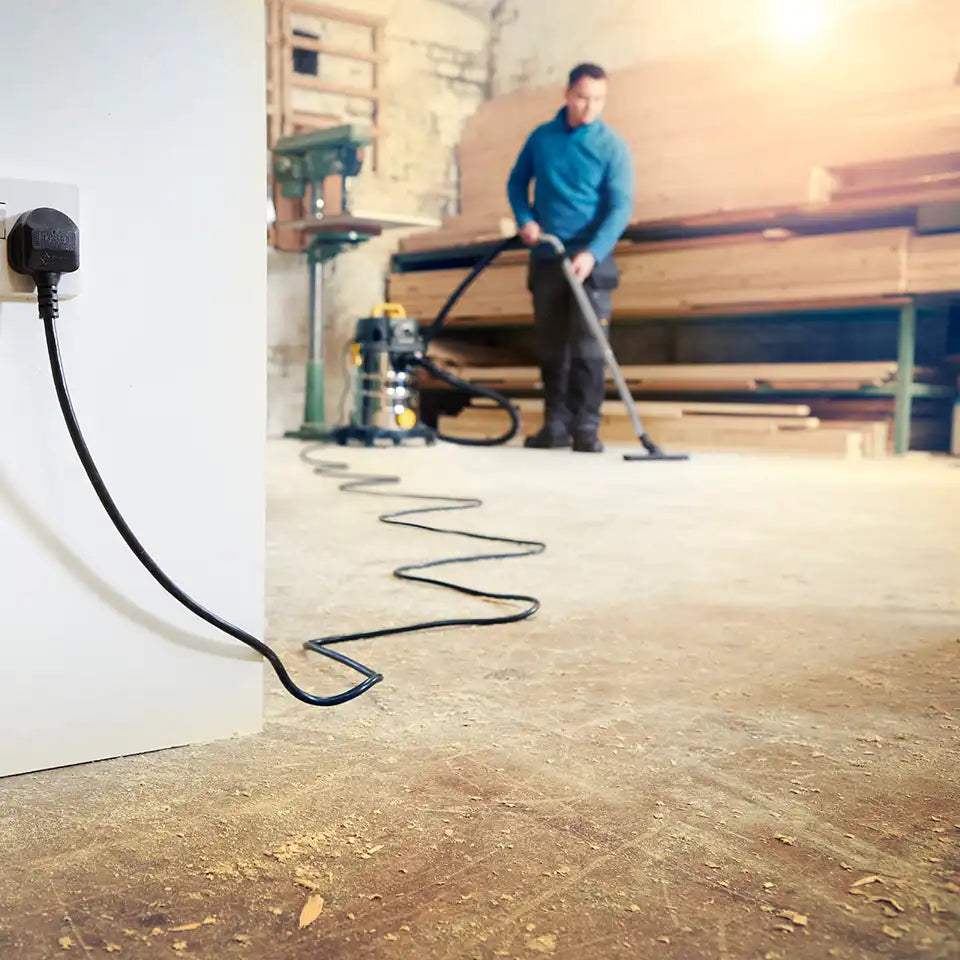 Vacmaster high specification wet and dry dust extractor with its long power cable in industrial setting